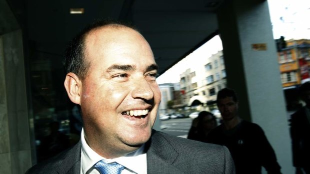 Former Australian cricket coach Mickey Arthur arrives with his legal team at the office in William Street, Sydney.