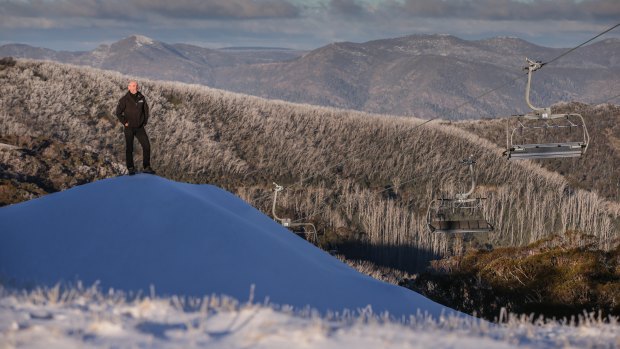 Mark Bennetts, CEO of Mt Buller and Mt Stirling Resorts, stands on a huge pile of man made snow. 