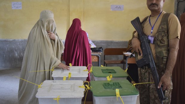 A woman casts her vote in Peshawar, Pakistan, on Wednesday.