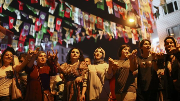 Women dance under election banners of the pro-Kurdish Peoples' Democratic Party, or HDP, in the mainly-Kurdish city of Diyarbakir.