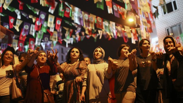 Women dance under election banners of the pro-Kurdish Peoples' Democratic Party, or HDP, in the mainly-Kurdish city of Diyarbakir.