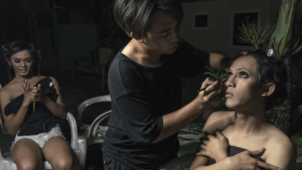 Contestant Kim Prahinog gets a touch-up on her eye makeup before an annual transgender beauty pageant in Maria Respondo.