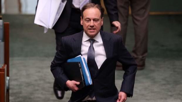 Environment minister Greg Hunt runs to his seat ahead of question time on Wednesday.