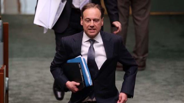 Environment minister Greg Hunt runs to his seat ahead of question time on Wednesday.