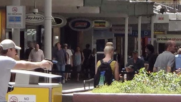 Lee Matthew Hillier (left) pictured during the Queen Street Mall siege on March 8, 2013.