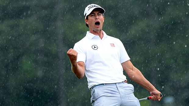 Adam Scott of Australia celebrates after making a birdie on the 18th hole to take the lead.