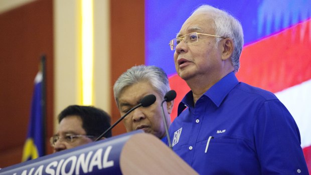 Najib Razak, Malaysia's outgoing prime minister, right, speaks during a news conference at the Barisan Nasional coalition headquarters in Kuala Lumpur, Malaysia, on Thursday.