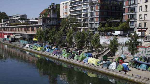 Tents where asylum seekers live are packed alongside of the canal Saint-Martin in Paris.