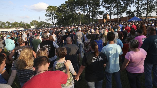People attend a prayer vigil following a shooting at Santa Fe High School.