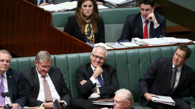 Communications Minister Malcolm Turnbull listens as Prime Minister Tony Abbott responds to a question on cabinet leaks during question time on Wednesday.