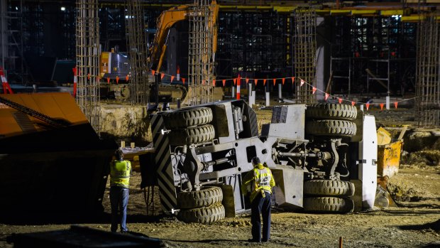 Police, paramedics, and WorkSafe on the University of Canberra Hospital construction site, where a crane is lying on its side after the August 2016 incident.