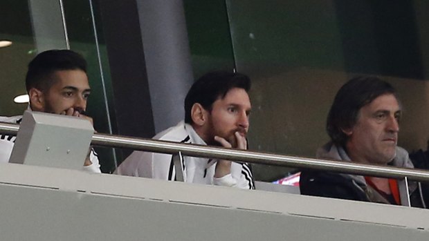 Beatdown: Lionel Messi watches from the stands as Spain thump Argentina.