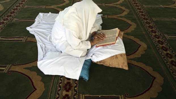 An Afghan Muslim man reads versus of the Quran in a mosque during Itikaf, the last ten days of the Islamic fasting month of Ramadan, in Kabul, Afghanistan.
