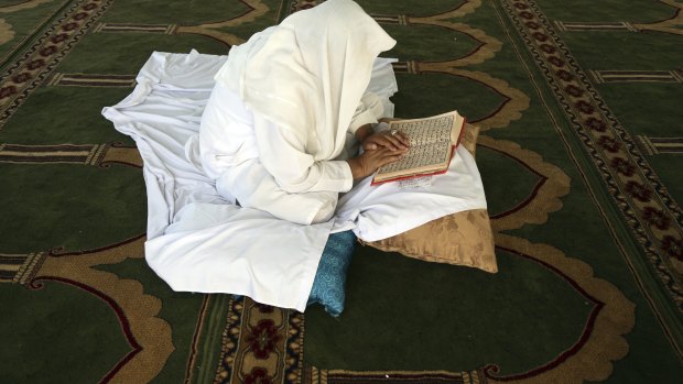 An Afghan Muslim man reads versus of the Quran in a mosque during Itikaf, the last ten days of the Islamic fasting month of Ramadan, in Kabul, Afghanistan.