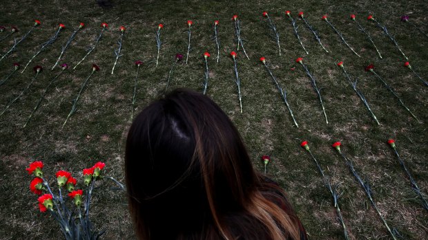 An activist places flowers on the West Front of the Capitol that they said are to memorialise children killed by Saudi bombings in Yemen, in Washington in March. 
