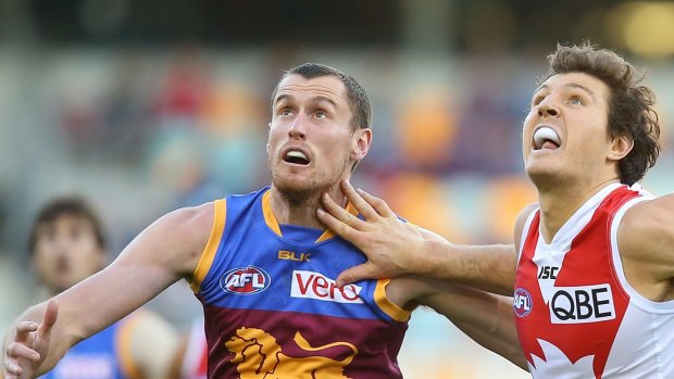 BRISBANE, AUSTRALIA - JULY 12:  Matthew Leuenberger of the Lions and Kurt Tippett of the Swans compete for the ball during the round 15 AFL match between the Brisbane Lions and the Sydney Swans at The Gabba on July 12, 2015 in Brisbane, Australia.  (Photo by Chris Hyde/Getty Images)