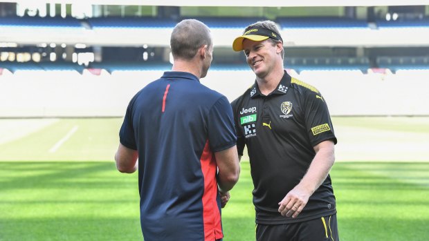 Melbourne coach Simon Goodwin and Richmond coach Damien Hardwick greet each other at the MCG on Monday. 