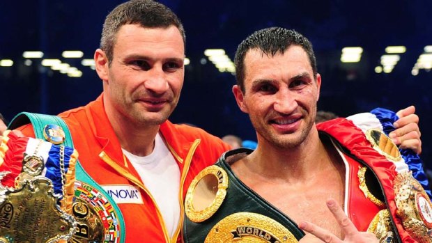“I tell you very openly: it’s much easier to be the heavyweight champion of the world than to be the mayor of Kiev": Vitali Klitschko, left, celebrates with his brother Wladimir.