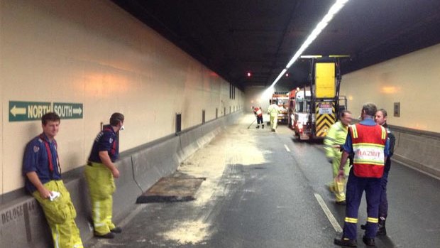Crews clean up a fuel spill in the Harbour Tunnel on Thursday.