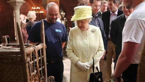 Queen Elizabeth II meets some of the costume and prop designers in the old Harland and Wolf paint room.