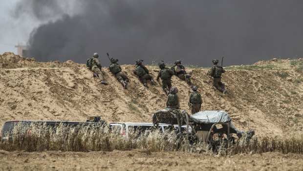 Israeli soldiers take position during protests along Israel Gaza border last month.