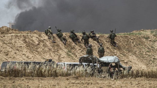 Israeli soldiers take position during protests along Israel Gaza border last month.