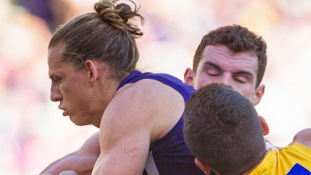 Crunched: Fremantle's Nat Fyfe gets double-teamed by West Coast defenders.