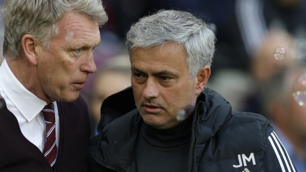 Exchanging words: West Ham manager David Moyes and his Manchester United counterpart, Jose Mourinho. 