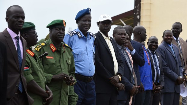 Australian citizen Yien Oral Lam, 48, from Alderley in Queensland, is seen here in his blue police uniform and beret at a ceremony to welcome rebel chief of military staff Simon Gatwech Dual back to Juba.