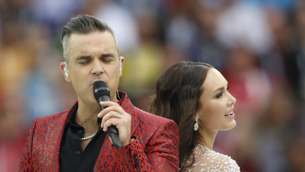 Duet: Robbie Williams and Aida Garifullina sing prior to the opening match. 