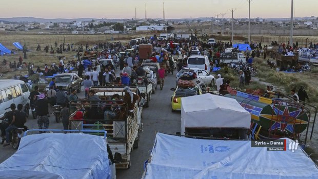 People who fled Daraa in their won vehicles gathering near the Syria-Jordan border. 