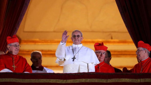 Newly-elected Pope Francis I appears on the central balcony of St Peter's Basilica.