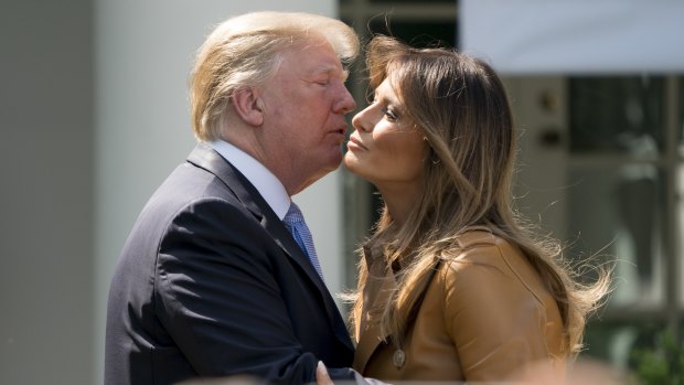 President Donald Trump kissed his wife on the cheeks five times after her presentation.