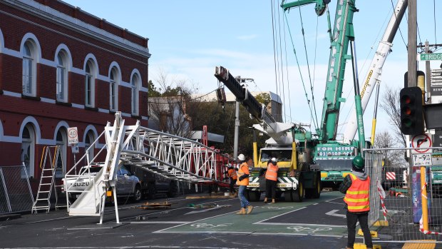 Part of a damaged construction crane is removed in Richmond.