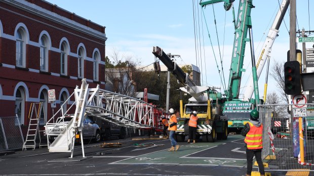 Part of a damaged construction crane is removed in Richmond.