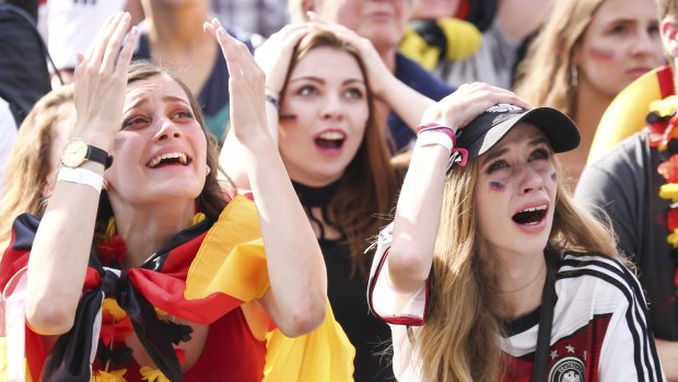 Crushing defeat: Germany fans mourn their early exit from the World Cup.