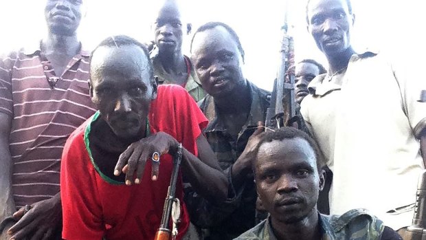 A photo from Makuer Mabor Mangar's Facebook page showing him (right, in fatigues) fighting for the rebels during the civil war. He has family in Sydney and Melbourne.