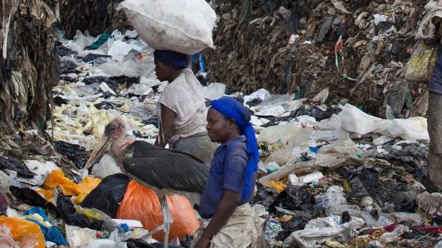 Men and women scavenge for recyclable materials amidst mountains of garbage and plastic bags at the dump in the Dandora slum of Nairobi, Kenya, before a ban on plastic bags came into force. 