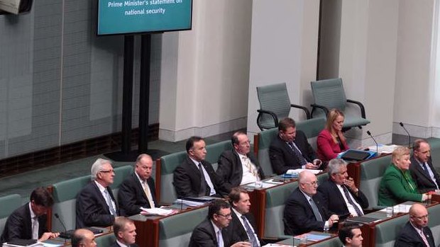 New screens on the floor of the House of Representatives display Prime Minister Tony Abbott's statement on national security on Monday. Photo: Andrew Meares