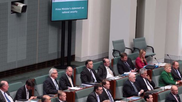 New screens on the floor of the House of Representatives display Prime Minister Tony Abbott's statement on national security on Monday. Photo: Andrew Meares