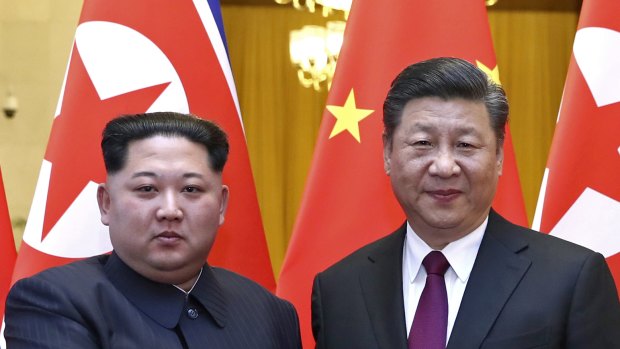 North Korean leader Kim Jong-un, left, and Chinese President Xi Jinping shake hands in Beijing, China. 