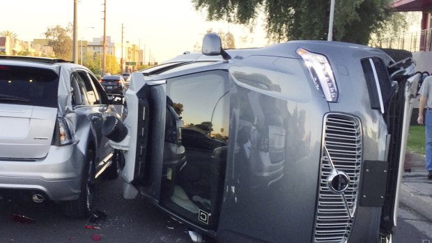 An Uber self-driving car that flipped on its side in a collision in Arizona.