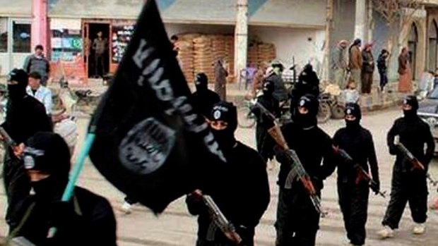 Fighters from the al-Qaeda-linked Islamic State of Iraq and the Levant (ISIL) marching in Raqqa, Syria.