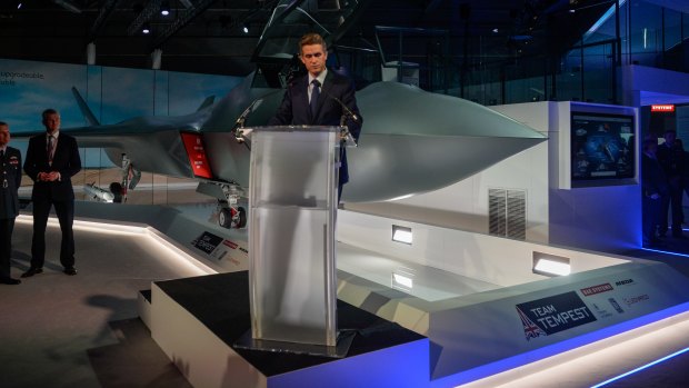 Gavin Williamson, UK defence secretary, stands at a lectern as a full-size model of a Tempest, UK's new fighter jet, is unveiled on the opening day of the Farnborough International Airshow 2018.