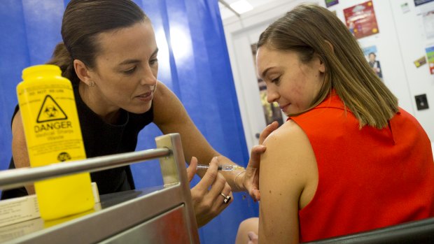 Pharmacist Jane Mitchell says she won't give the flu jab just yet unless the patient is in a high-risk group or heading overseas.