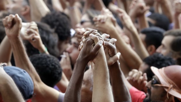 Supporters of Brazilian former President Luiz Inacio Lula da Silva hold hands during a protest against the warrant for his arrest, outside the metal workers headquarters in Sao Bernardo do Campo, Brazil.