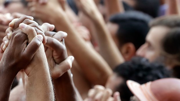 Supporters of Brazilian former President Luiz Inacio Lula da Silva hold hands during a protest against the warrant for his arrest, outside the metal workers headquarters in Sao Bernardo do Campo, Brazil.