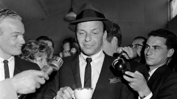 Centre of attention: US singer and actor Frank Sinatra is surrounded during a visit to Sydney in 1961.