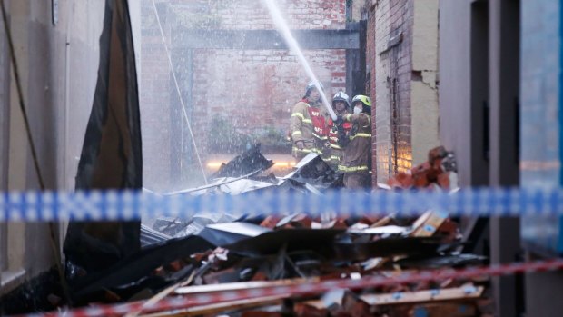 MFB fire crews work to put out the last of the flames at a fire inside a restaurant in Lygon street in Carlton