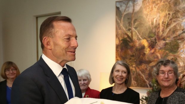 Prime Minister Tony Abbott meets with Audrey Schultz and members of the ACT Embroiderers' Guild at Parliament House on Monday.